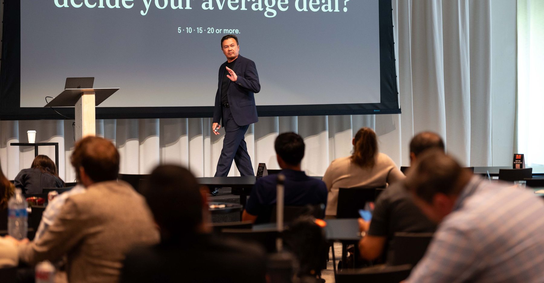 Dmitri Lee on the main stage at Sol/Con 2026 in Chicago, asking a full room how many people really decide their average deal